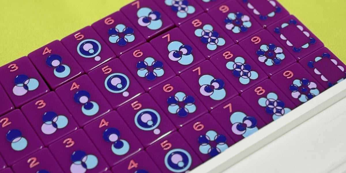 Purple numbered tiles with blue circular patterns in a tray